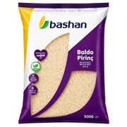 Bashan Baldo Pirinç-ris i 5 kg förpackning, vit och lila design med ris.