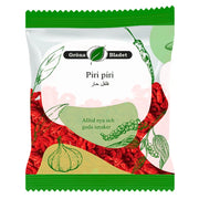 Påse med piri piri chili, orientaliska kryddor, gröna illustrationer av vitlök och peppar.