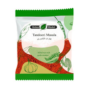 Påse med Gröna Bladet Tandoori Masala 40g kryddmix, vit och grön förpackning med kryddillustrationer.
